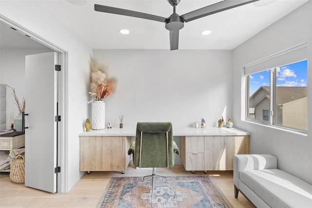 sitting room with ceiling fan, light hardwood / wood-style flooring, and built in desk