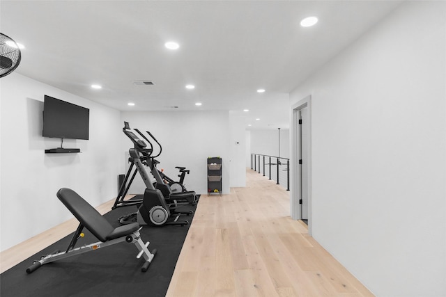 workout room with light hardwood / wood-style flooring