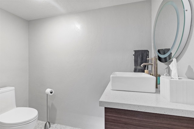 bathroom featuring toilet and vanity