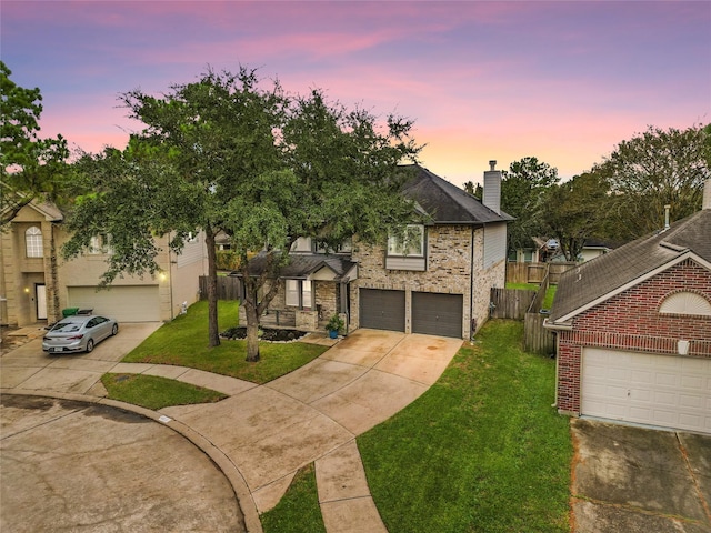 view of front of home with a garage and a lawn