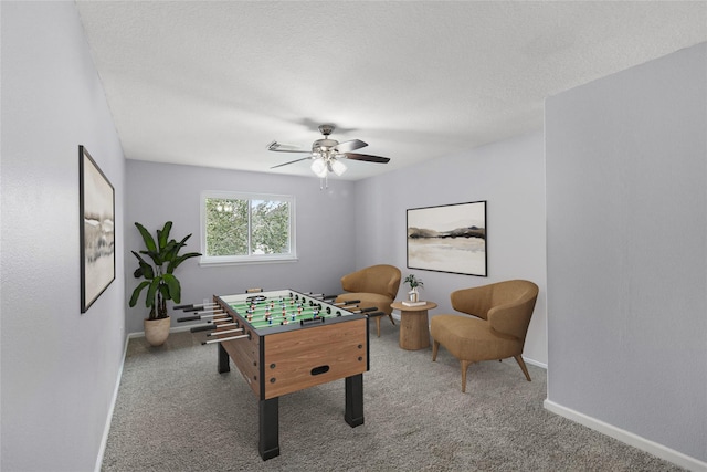 recreation room with carpet floors and ceiling fan