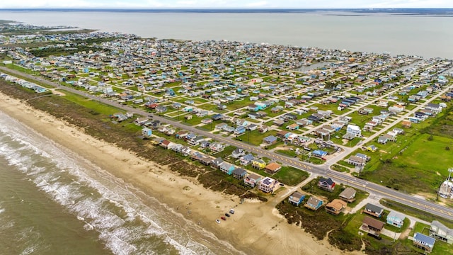 birds eye view of property featuring a view of the beach and a water view