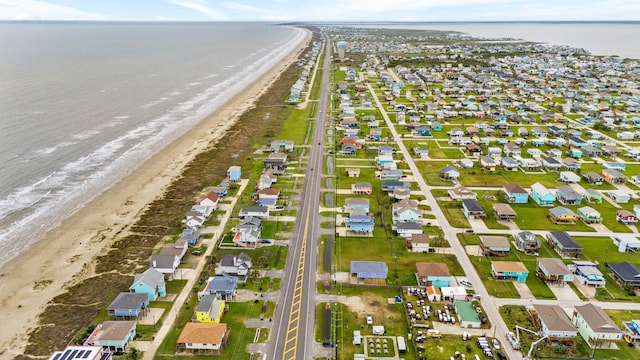 drone / aerial view featuring a water view and a beach view