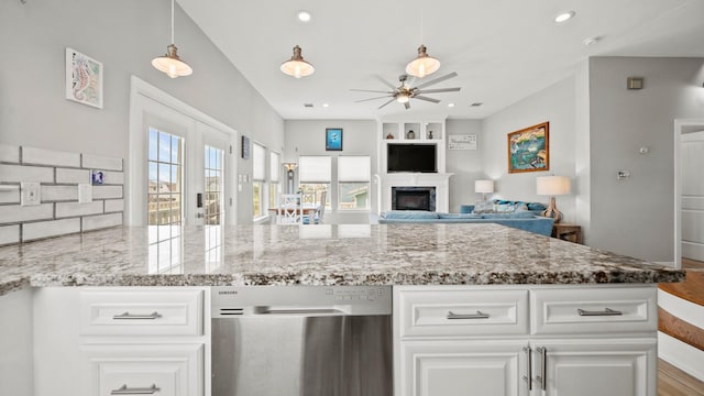 kitchen with white cabinetry, ceiling fan, light stone countertops, light hardwood / wood-style flooring, and decorative light fixtures