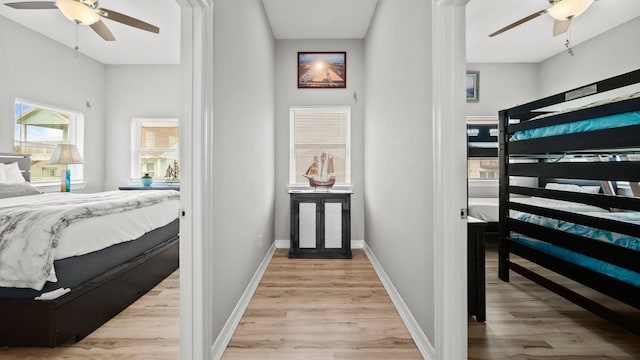 bedroom with light hardwood / wood-style flooring and ceiling fan