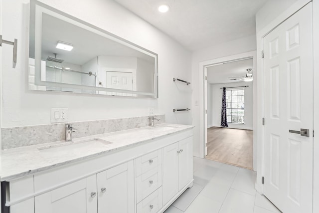 bathroom featuring tile patterned flooring, a shower, vanity, and ceiling fan