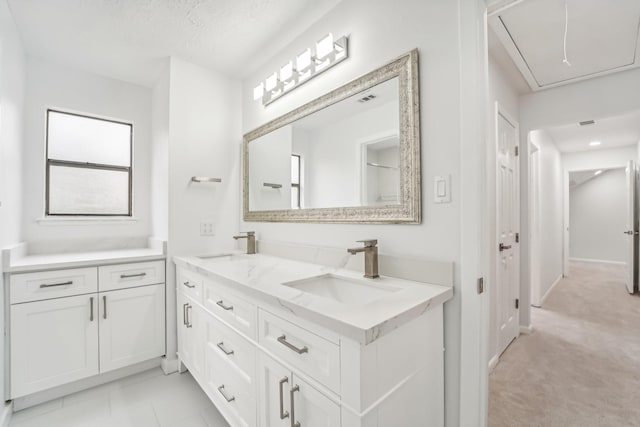 bathroom with vanity and a textured ceiling