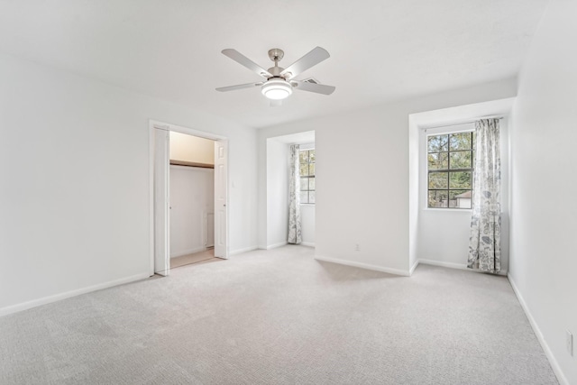 unfurnished bedroom featuring light colored carpet and ceiling fan