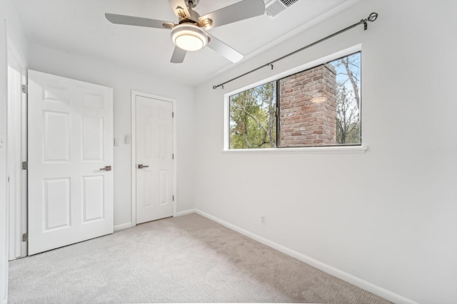 unfurnished bedroom with ceiling fan and light carpet