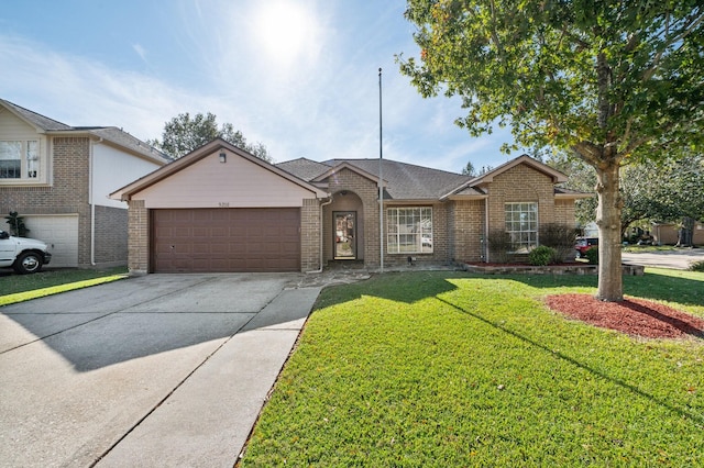 ranch-style home featuring a garage and a front lawn