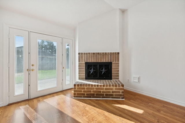 doorway featuring hardwood / wood-style floors and a fireplace