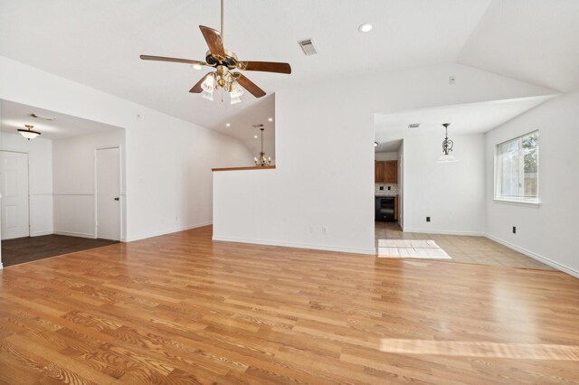 unfurnished living room featuring light wood-type flooring, vaulted ceiling, and ceiling fan