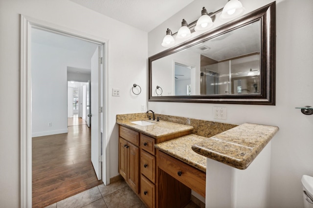 bathroom with vanity and wood-type flooring