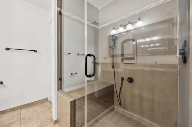 bathroom featuring tile patterned flooring and a shower with shower door