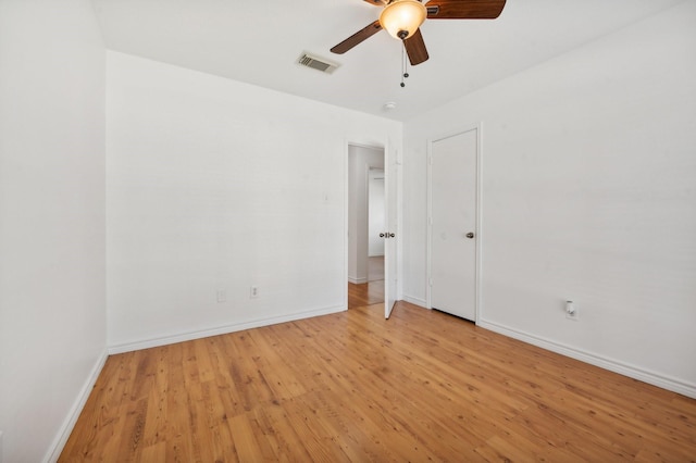 empty room with light hardwood / wood-style floors and ceiling fan