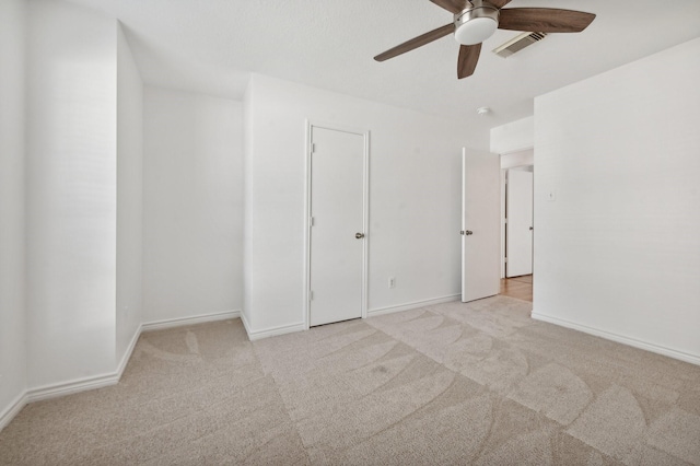 unfurnished bedroom featuring ceiling fan and light carpet