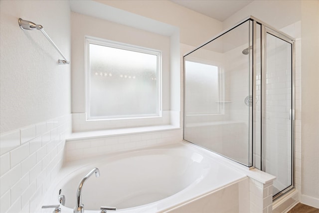 bathroom featuring separate shower and tub