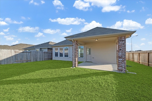 rear view of house featuring a patio and a lawn