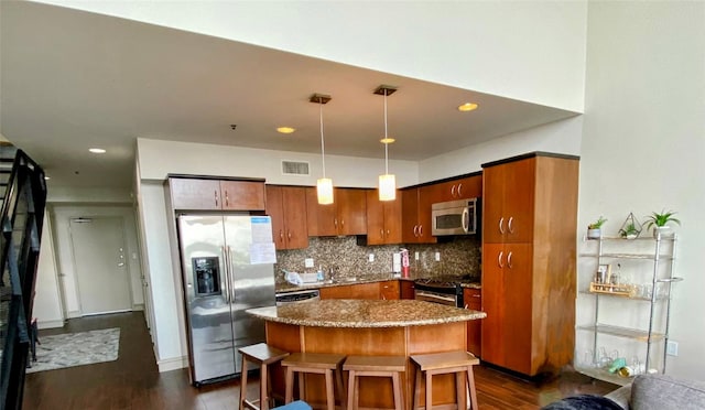 kitchen featuring visible vents, appliances with stainless steel finishes, decorative backsplash, and dark wood-type flooring