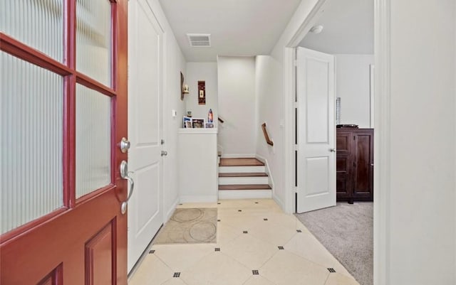 view of carpeted entrance foyer