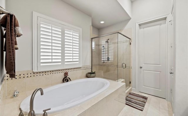 bathroom with tile patterned floors and independent shower and bath