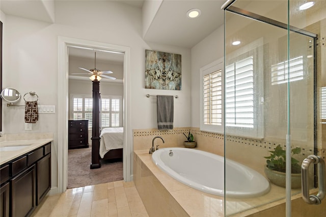 bathroom with separate shower and tub, ceiling fan, and vanity