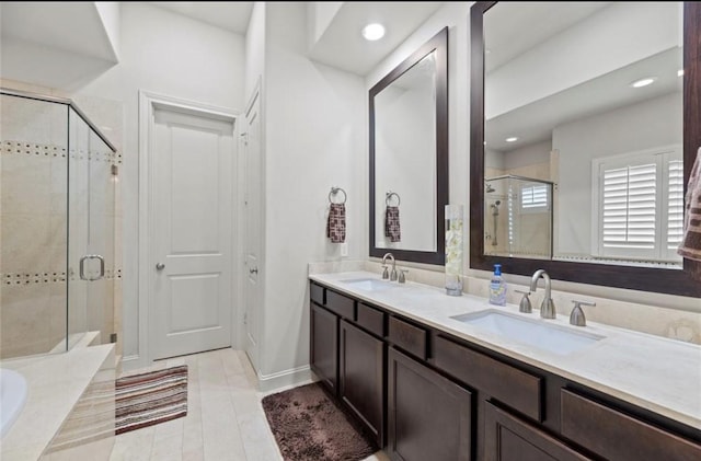 bathroom featuring vanity and independent shower and bath