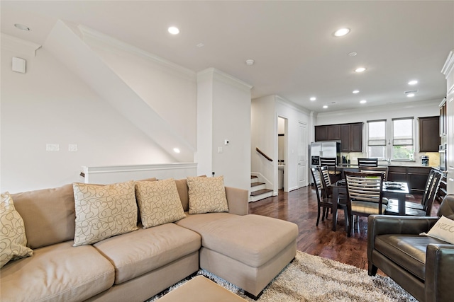 living room with dark wood-type flooring and ornamental molding