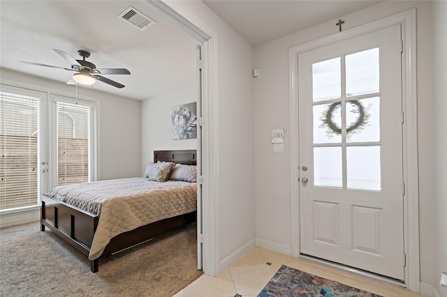 bedroom featuring access to outside, multiple windows, ceiling fan, and light tile patterned floors