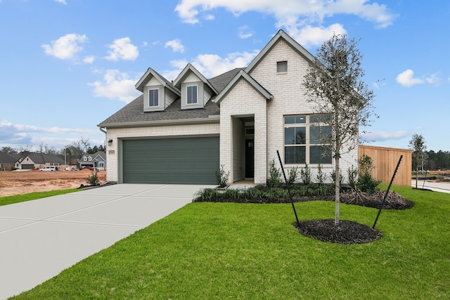 view of front of property featuring a garage and a front lawn