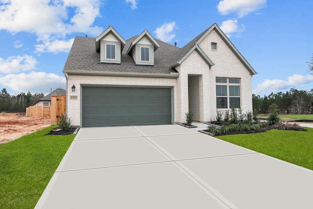 view of front of home featuring a garage and a front lawn