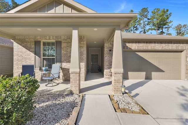 doorway to property featuring a porch and a garage