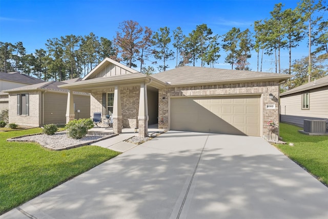 view of front of house featuring covered porch, central AC, a garage, and a front yard