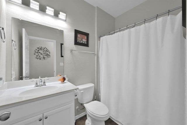 bathroom with a shower with curtain, vanity, and toilet