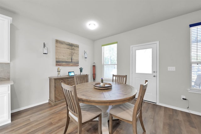 dining space featuring hardwood / wood-style floors and plenty of natural light