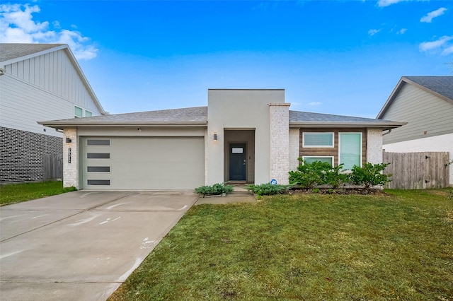 view of front of home featuring a garage and a front lawn