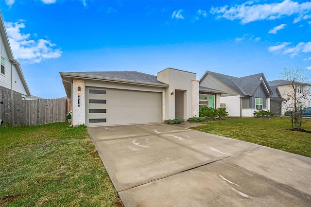 view of front of home featuring a front lawn and a garage