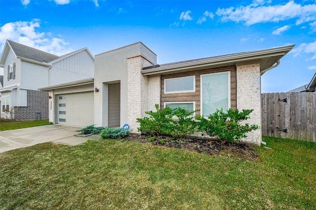 view of front of home featuring a front lawn and a garage