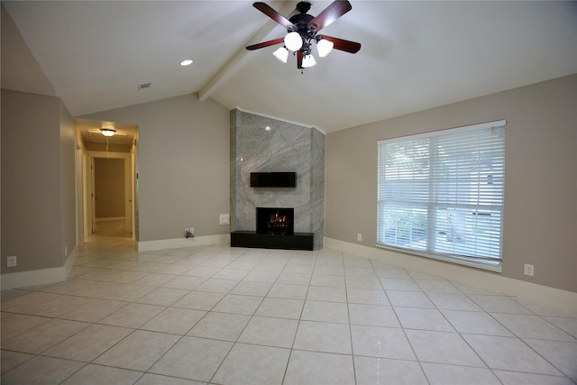 unfurnished living room with a high end fireplace, vaulted ceiling with beams, ceiling fan, and light tile patterned floors