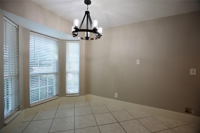 unfurnished dining area featuring a chandelier and light tile patterned floors