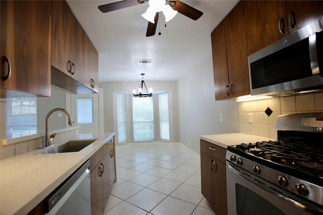 kitchen with backsplash, a wealth of natural light, sink, and stainless steel appliances