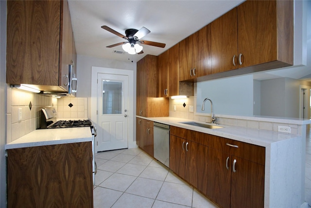 kitchen featuring decorative backsplash, stainless steel appliances, ceiling fan, sink, and light tile patterned floors