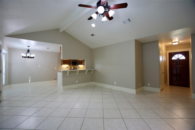 unfurnished living room with ceiling fan with notable chandelier, lofted ceiling with beams, and light tile patterned flooring