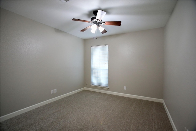 spare room featuring carpet and ceiling fan