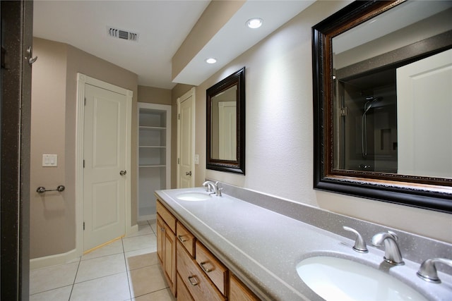 bathroom featuring tile patterned flooring and vanity