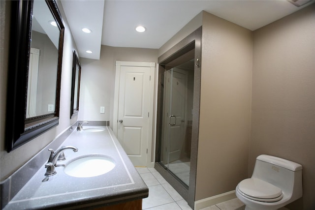 bathroom featuring tile patterned flooring, vanity, toilet, and a shower with door