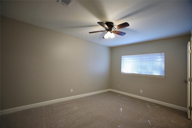 carpeted spare room with ceiling fan