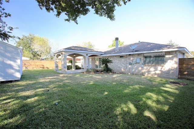 rear view of property featuring a yard