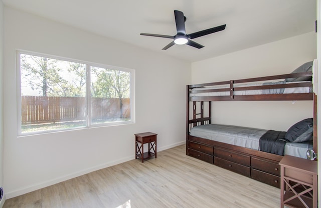 bedroom with ceiling fan and light hardwood / wood-style flooring