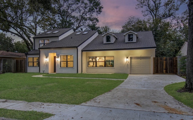 view of front of house featuring a garage and a yard